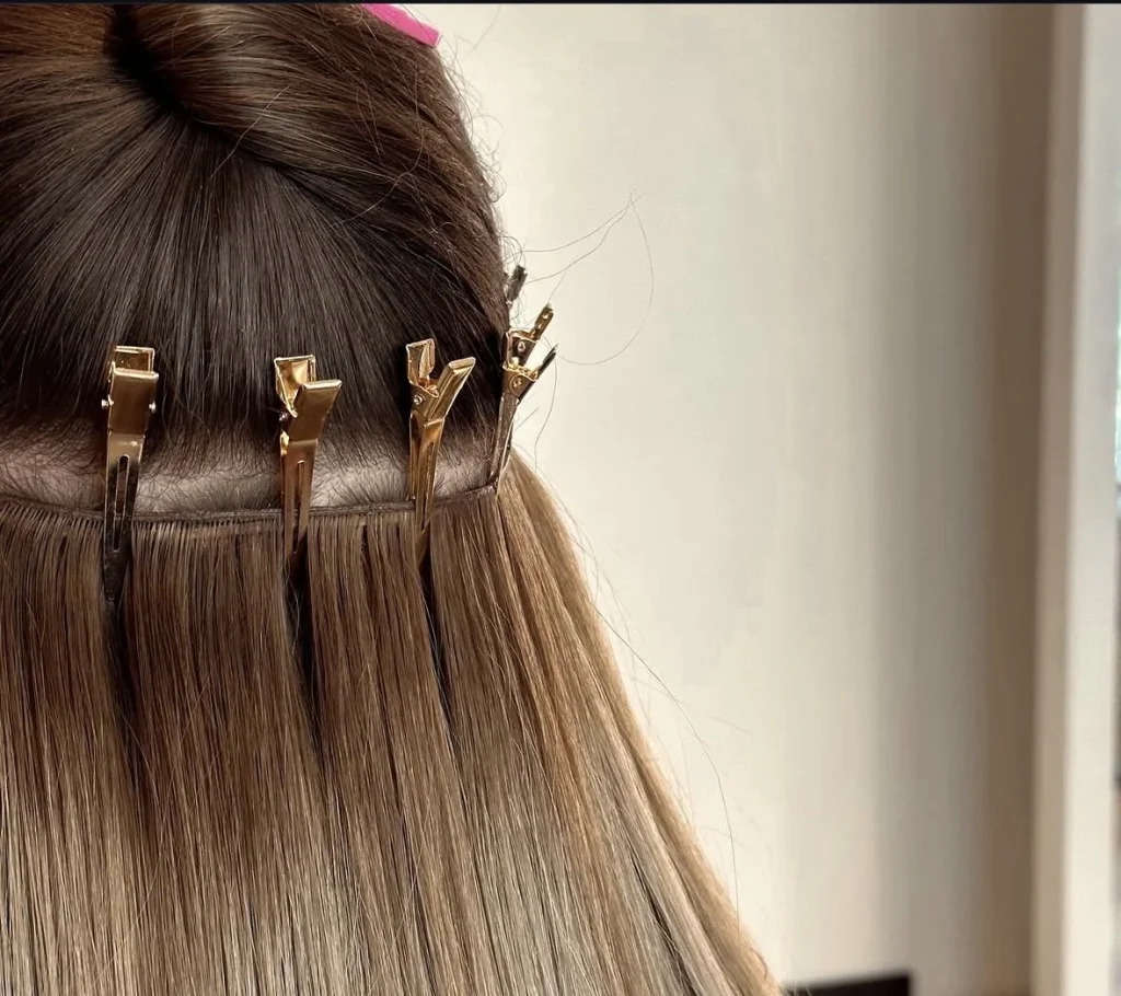 Hair is being sectioned with clips for styling or treatment