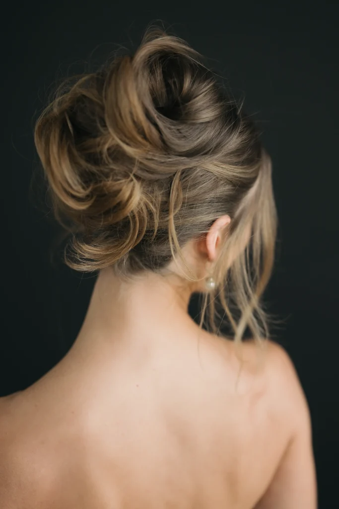 A woman with a stylish updo turns her back to the viewer