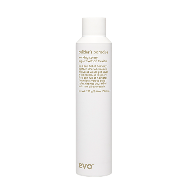 A sleek white bottle labeled "Builder's Paradise" stands against a black background