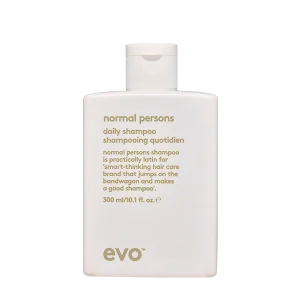 A white shampoo bottle with a minimalist design and descriptive text