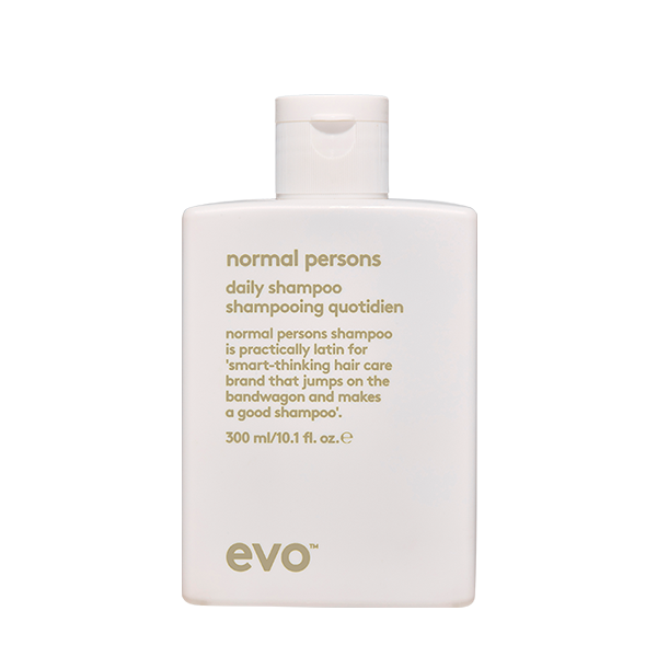 A white shampoo bottle with a minimalist design and descriptive text