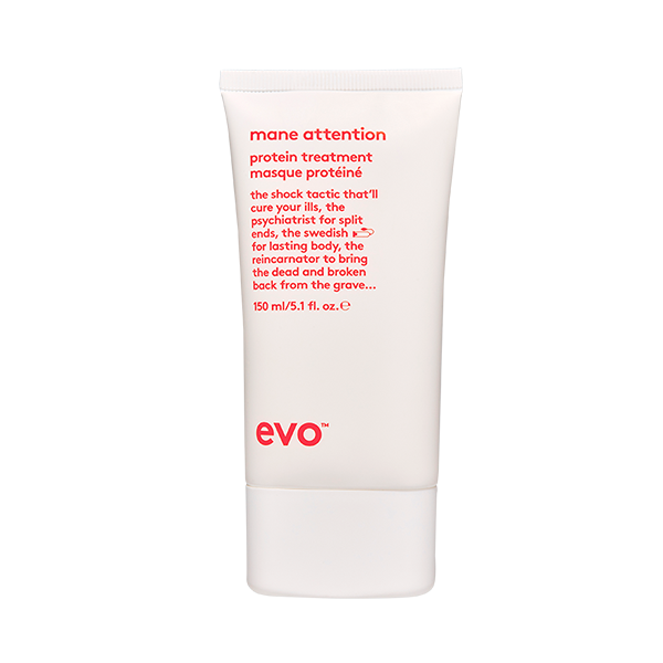 A sleek, white tube of hair treatment product with red text stands upright