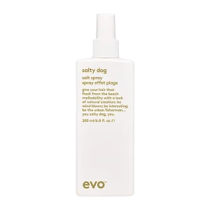 A sleek, white spray bottle labeled "Salty Dog" stands upright, exuding a beachy vibe