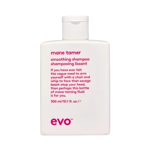 A white shampoo bottle with pink text sits against a black background