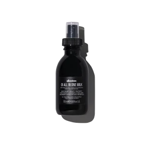 A dark glass bottle with a black label and spray nozzle is displayed