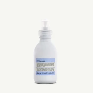 A sleek, white spray bottle stands upright against a neutral background