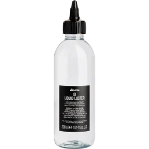 A clear spray bottle with a black label and nozzle stands upright