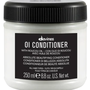 A white jar labeled "OI Conditioner" with a dark lid and multi-language text