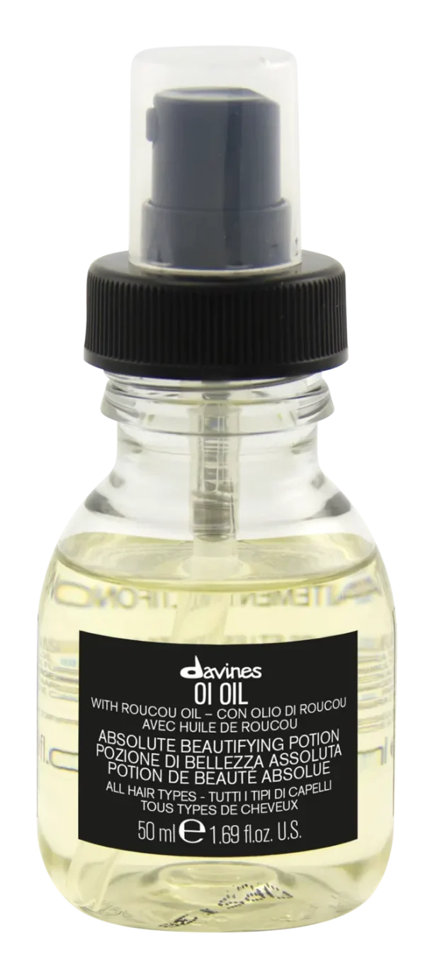 A small clear bottle contains a light-colored liquid with a black label and a spray nozzle