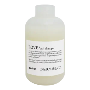 A bottle of curl-enhancing shampoo with a minimalist design and simple label