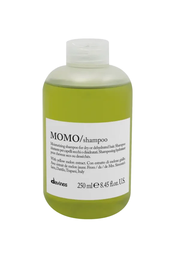 A clear bottle of green shampoo with a minimalist label