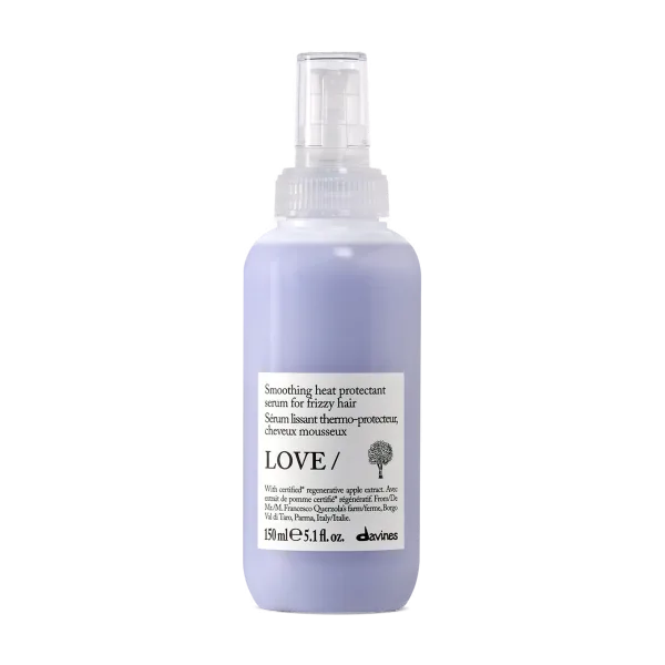 A lavender-colored spray bottle with a clear nozzle and a white label