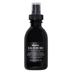 A black spray bottle with a label displaying hair treatment instructions
