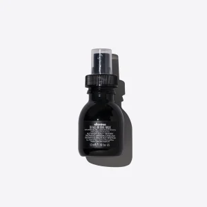 A sleek black bottle with a spray nozzle casts a subtle shadow