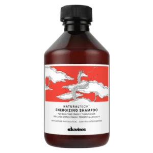A bottle of shampoo features a dragon design on a vibrant red background
