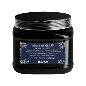 A sleek, black jar showcases a labeled hair treatment product with a floral design