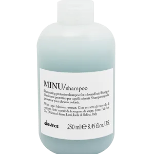 A translucent blue shampoo bottle displays its brand and product information prominently