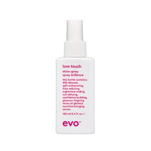 A clear spray bottle with a white label and pink text sits upright