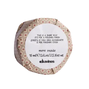 A round container with decorative patterns and text about a shine wax product
