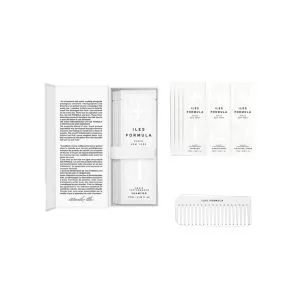 A sleek box contains several vials and a comb, emphasizing elegance and minimalism