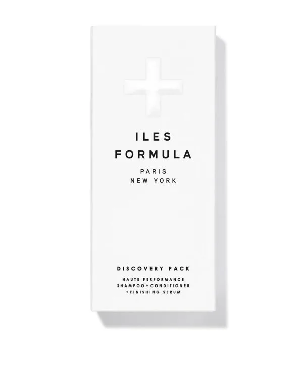 A sleek white packaging features minimalistic text and a cross symbol