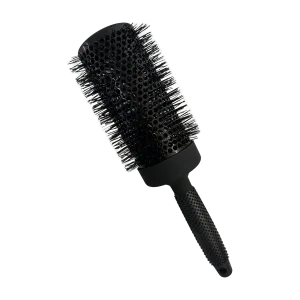 A round brush with a textured handle and bristles for hairstyling