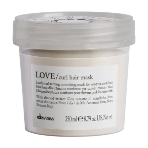 A jar of curl hair mask sits prominently, showcasing its creamy texture and elegant label