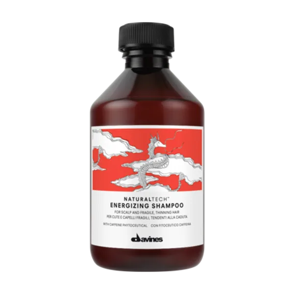 A dark bottle of energizing shampoo features a bold, illustrated design with a dragon and clouds