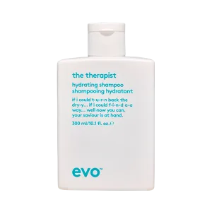 A sleek shampoo bottle features a white design with blue text and a flip-top lid
