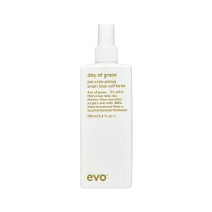 A sleek, white spray bottle with a minimalist design and a label in elegant font