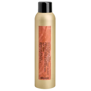 A sleek, gold-colored bottle with a dark cap and a patterned label