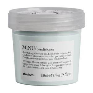 A light blue container of conditioner sits with a clear lid, labeled "MINU/conditioner."