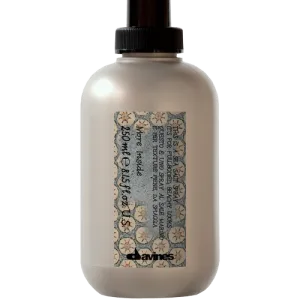 A bottle of hair product with decorative labeling and a spray nozzle