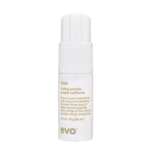 A small, white bottle of styling powder with a pump dispenser and elegant branding