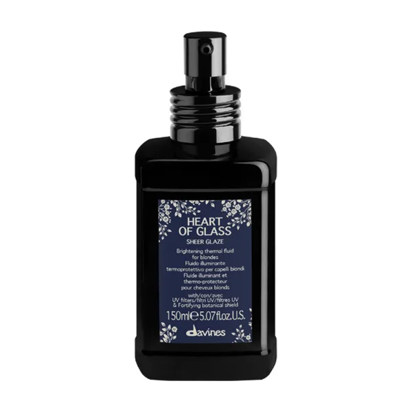 A dark glass bottle with a black spray nozzle and floral label