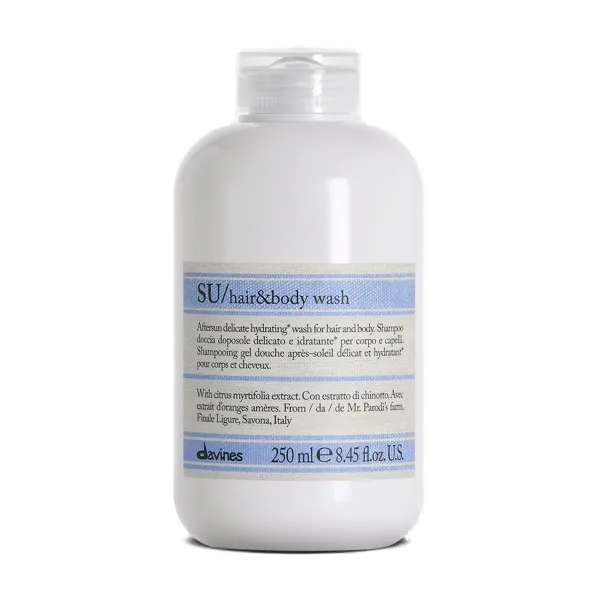 A white bottle with a blue label contains hair and body wash