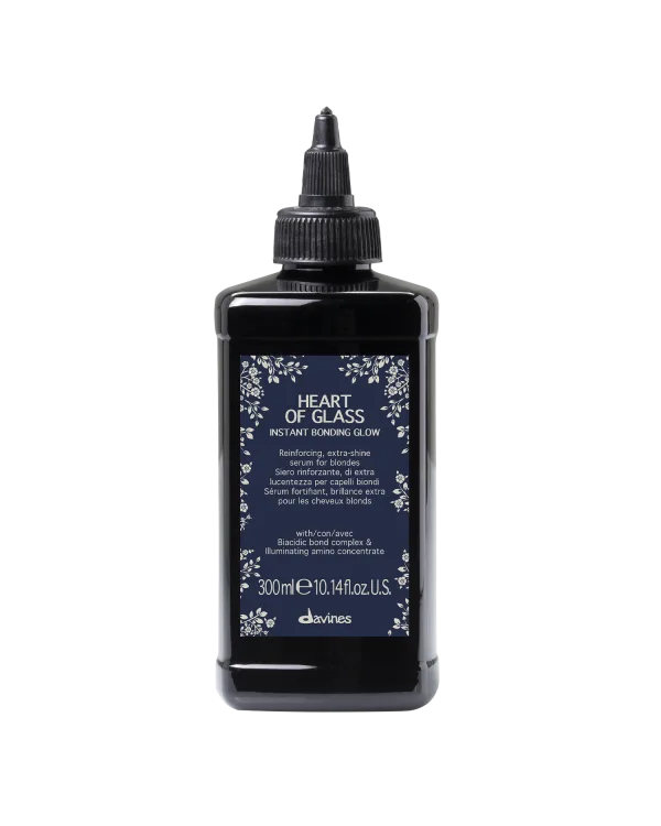 A dark bottle labeled "Heart of Glass" displays floral designs and detailed instructions