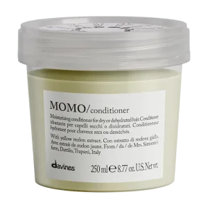 A light green conditioner in a clear container with a white lid