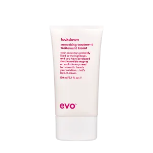 A sleek white tube with pink text contains a smoothing treatment product