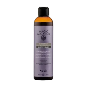 A bottle of purple shampoo labeled "Magic Argan Oil" sits against a plain background