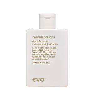 A sleek, white shampoo bottle with minimalist design and elegant font