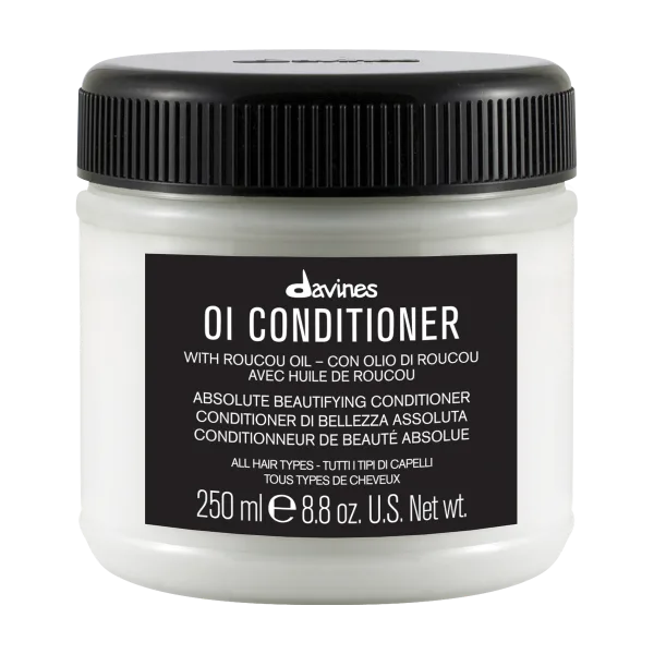 A white jar of conditioner features a black label with product details