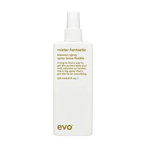 A sleek spray bottle with a minimalist design sits against a plain background