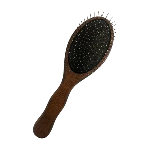 A wooden hairbrush with a padded surface and bristles lies flat