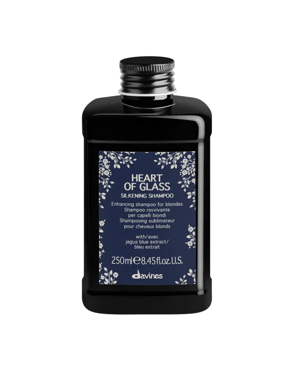 A sleek black shampoo bottle features elegant floral designs and a bold label