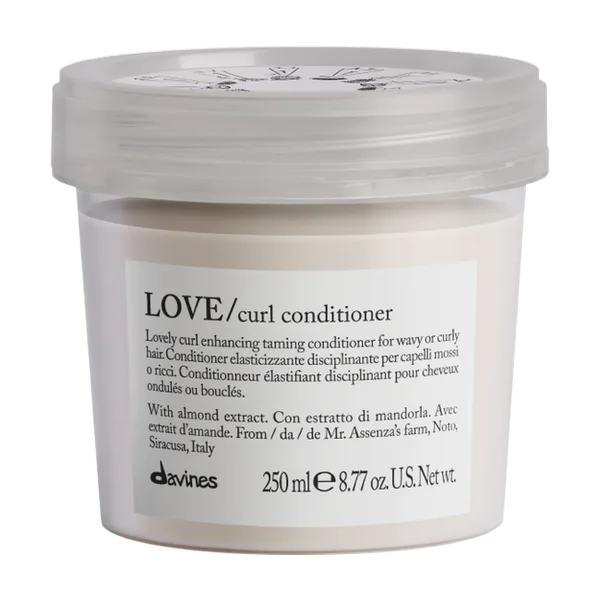 A jar of curl conditioner with a light cream color and simple packaging