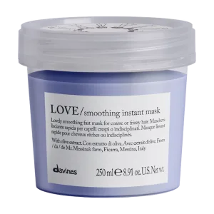 A lavender hair mask container sits on a light background, showcasing its product label