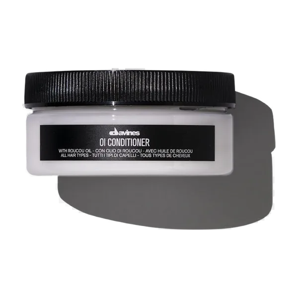 A black-lidded container labeled "Oil Conditioner" is displayed against a neutral background
