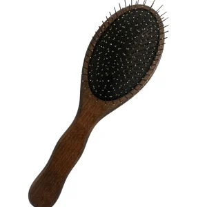 A wooden hairbrush with metal bristles rests on a plain background
