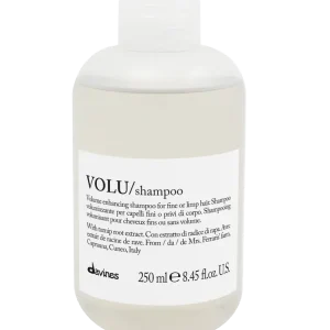 A clear bottle filled with light-colored shampoo is displayed prominently
